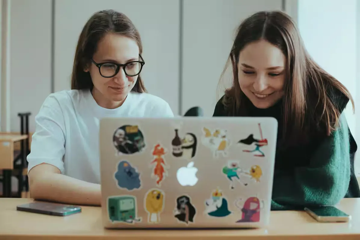 Two participants working together on a laptop